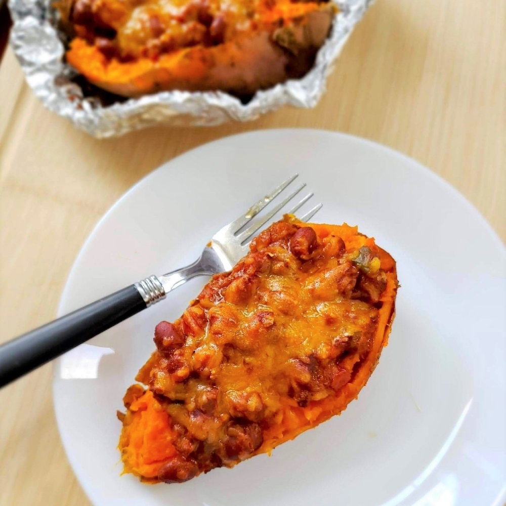 Grilled Chili and Cheese Stuffed Sweet Potatoes cooked in a foil packet for camping