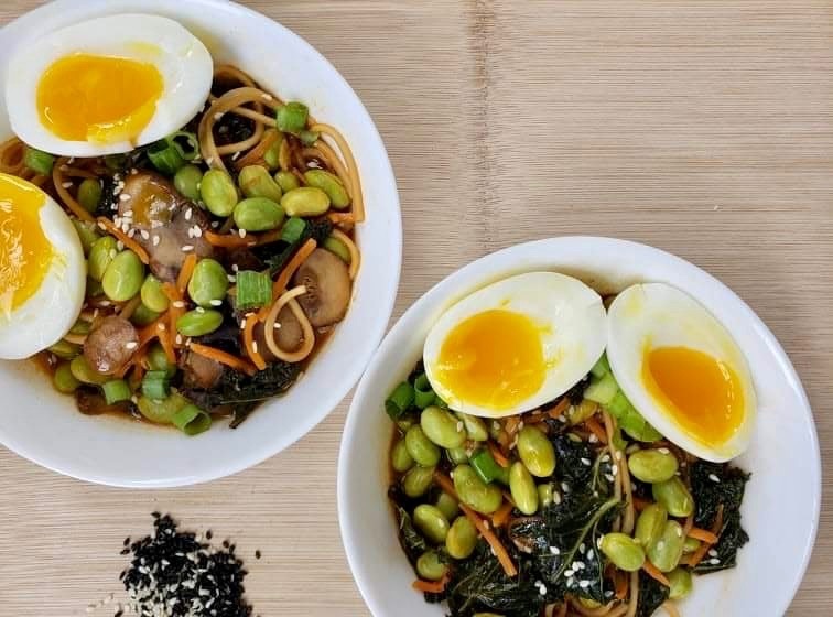Homemade ramen noodle bowls with eggs and edamame for a protein boost