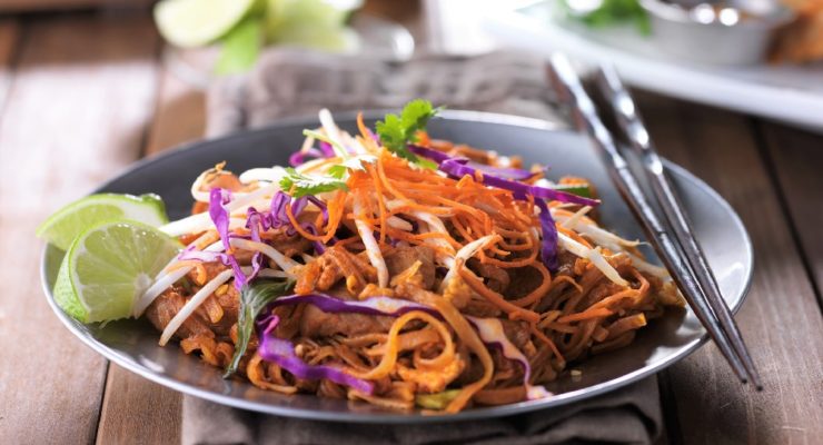 Instant Pot Chicken Pad Thai with vegetables, limes and chopsticks