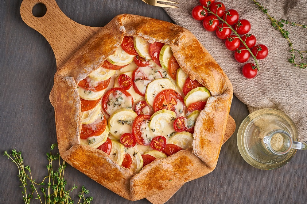 healthy homemade vegetable galette with tomatoes, zucchini and cheese
