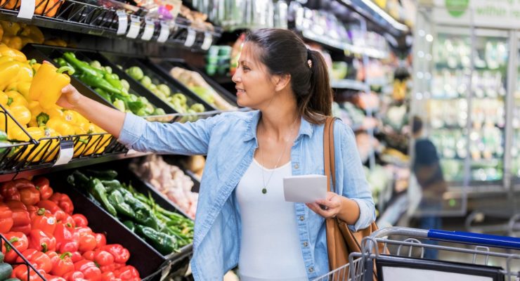 Woman chooses produce at grocery store