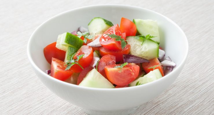 A healthy vinegar salad with tomato, cucumber and onion