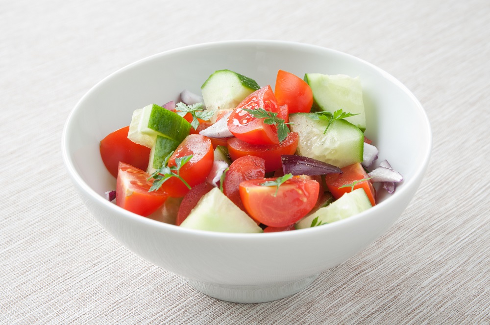 A healthy vinegar salad with tomato, cucumber and onion