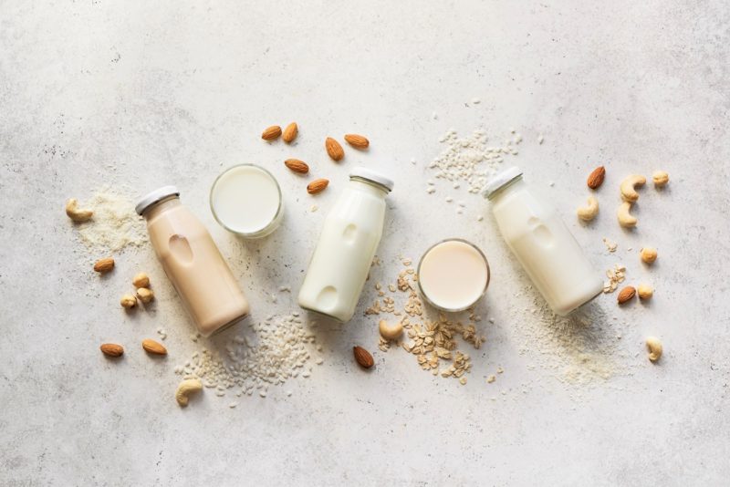 Bottles of fresh almond milk, cashew milk, and other nut milks