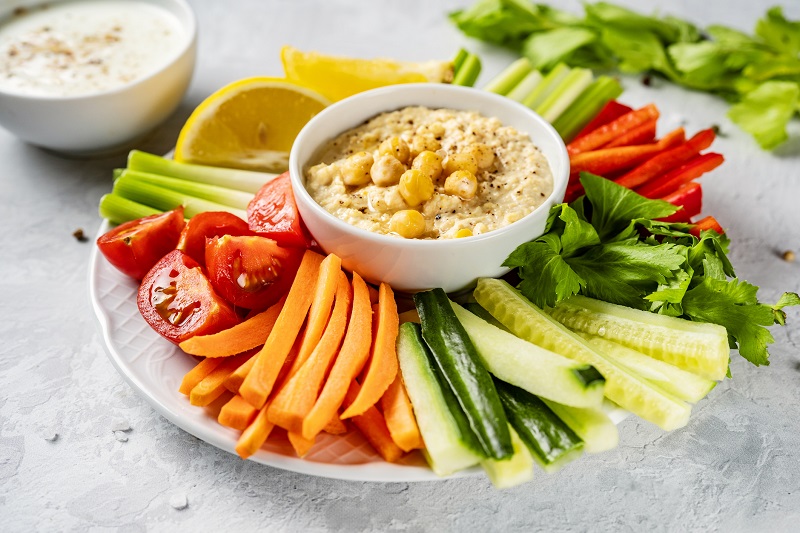 hummus and colorful sliced vegetables