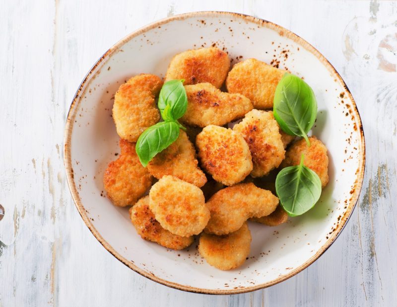 Crispy chicken nuggets on a plate.