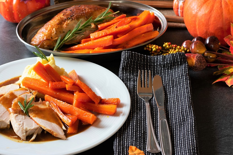 thanksgiving plate full of turkey, carrots and mashed potatoes