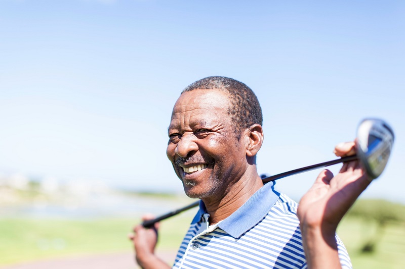Smiling man with a golf club