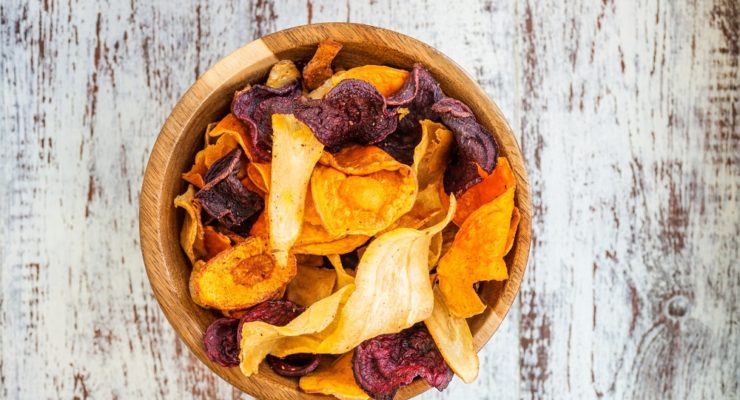 Wooden bowl of colorful and healthy root vegetable chips