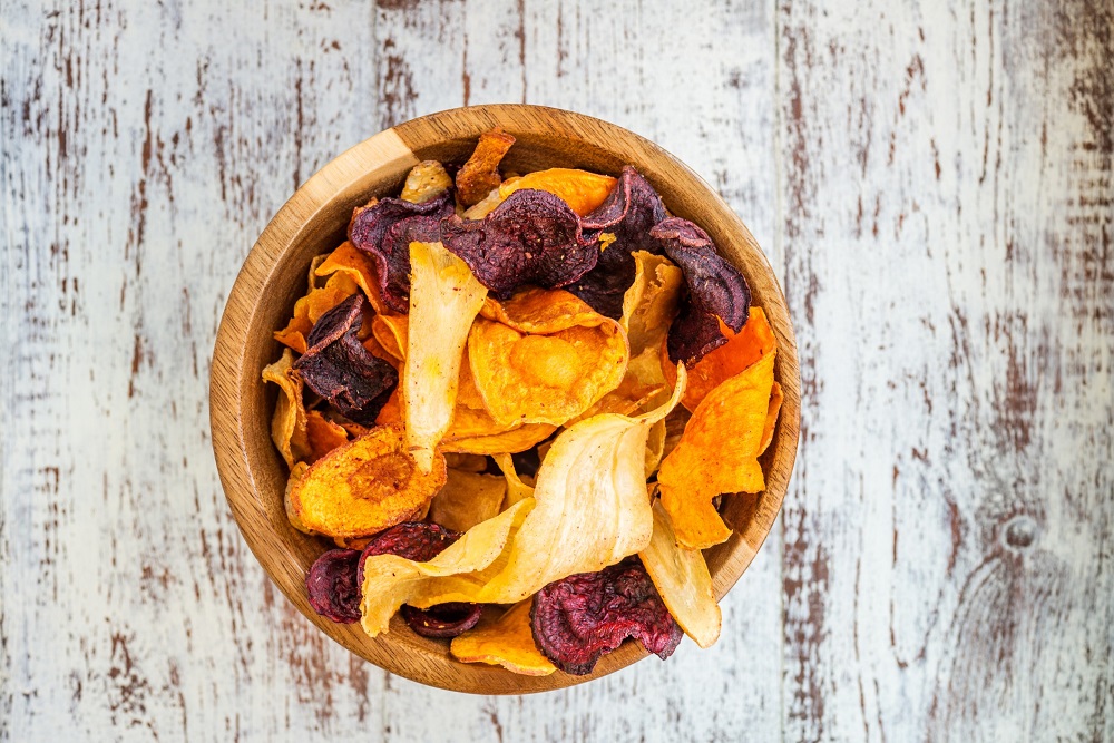 Wooden bowl of colorful and healthy root vegetable chips