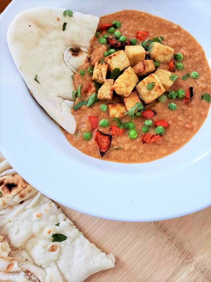 Bowl of tofu tikka masala with naan from the air fryer