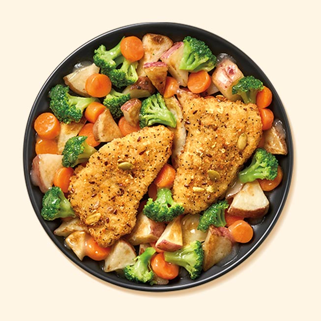 Grain-crusted pollock with vegetables in a bowl