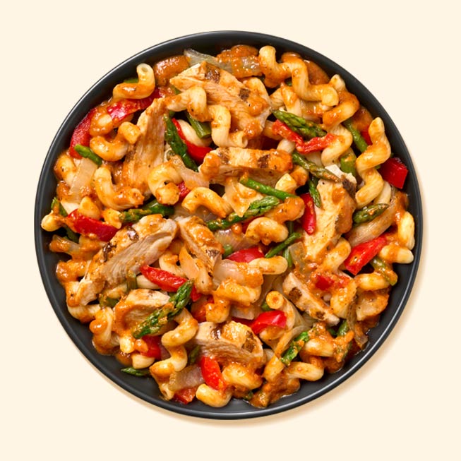 Red pepper chicken and pasta in a bowl