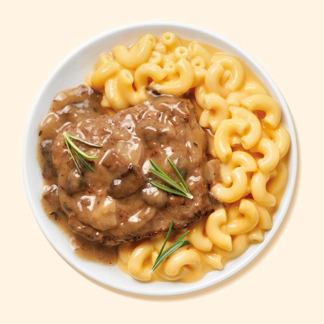 Salisbury steak with mac and cheese on a plate