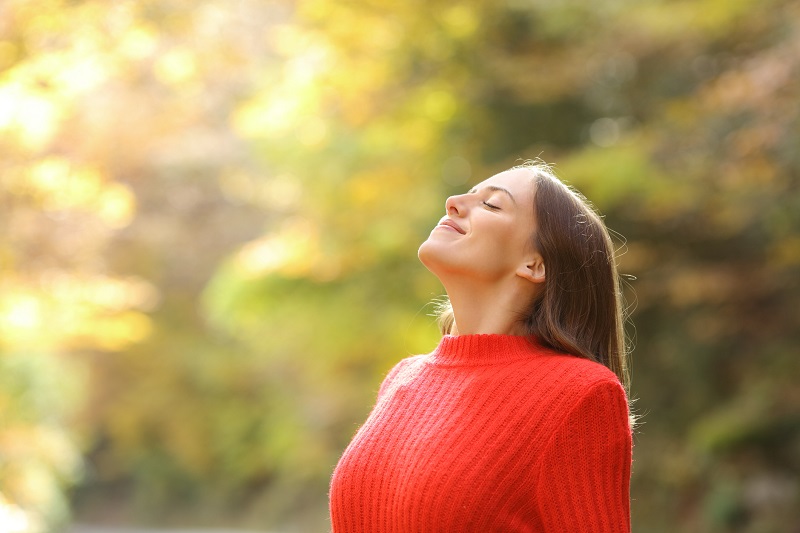Woman outside breathing in fresh air