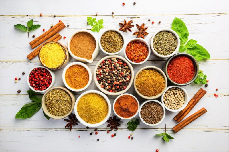 Colorful assortment of herbs and spices in bowls
