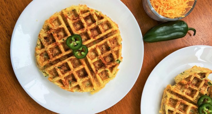 Cheddar Jalapeno Waffles on a plate with a side of cheese and peppers