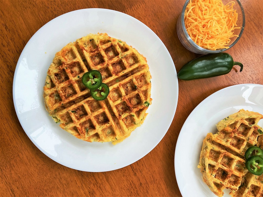 Cheddar Jalapeno Waffles on a plate with a side of cheese and peppers