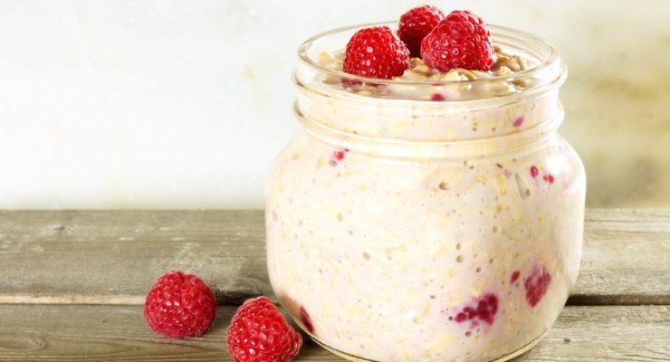 berry cheesecake overnight oats in a jar with raspberries