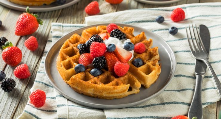 waffles topped with berries and whipped cream