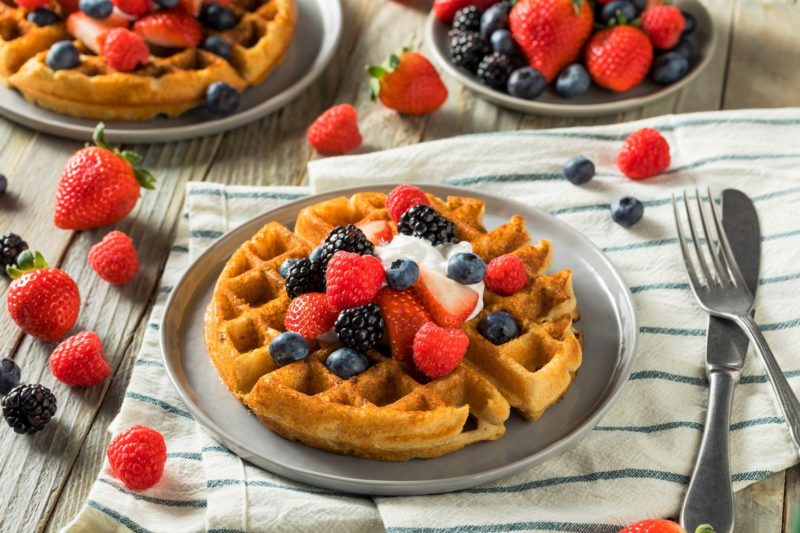 waffles topped with berries and whipped cream