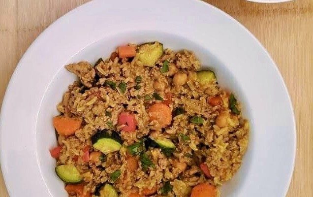 Curried Turkey with rice and vegetables in a white bowl