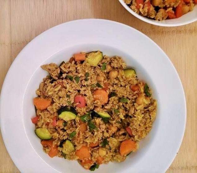 Curried Turkey with rice and vegetables in a white bowl