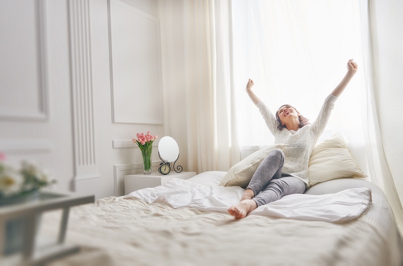 Woman stretches after waking up from a power nap