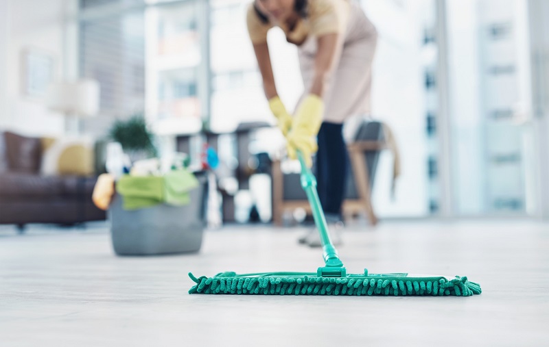 A woman mopping the floor