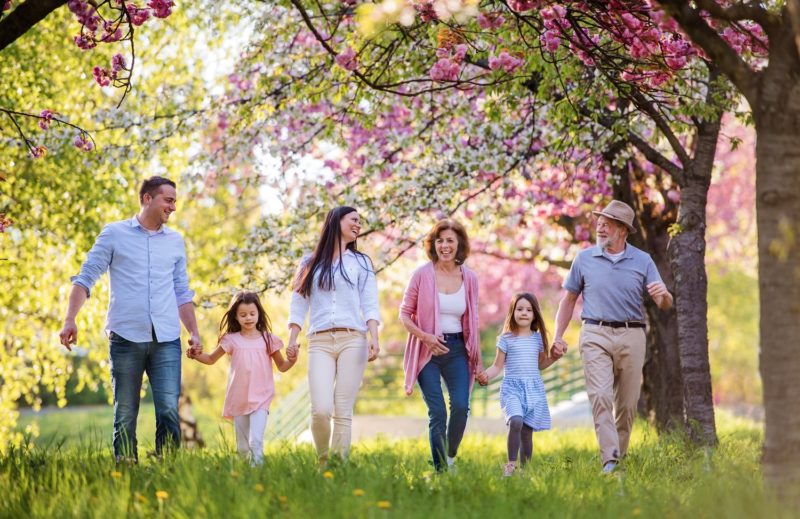 Three generation family walking outside in spring