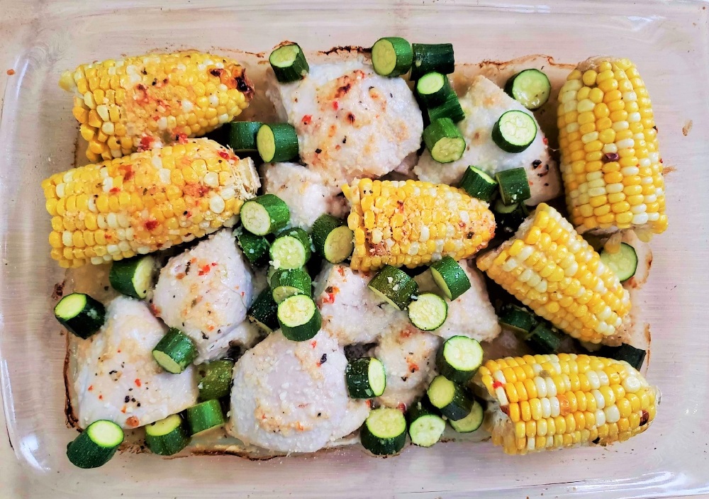 Baked Chicken, Corn and Zucchini in a glass baking dish
