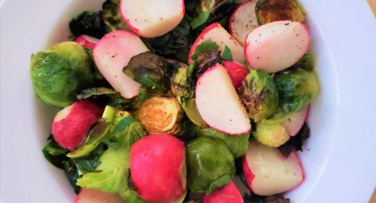 Roasted Radishes and Brussels Sprouts in a white serving bowl