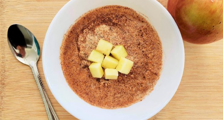 Apple and Cinnamon Blended Overnight Oats with chopped apples and a spoon in a white bowl