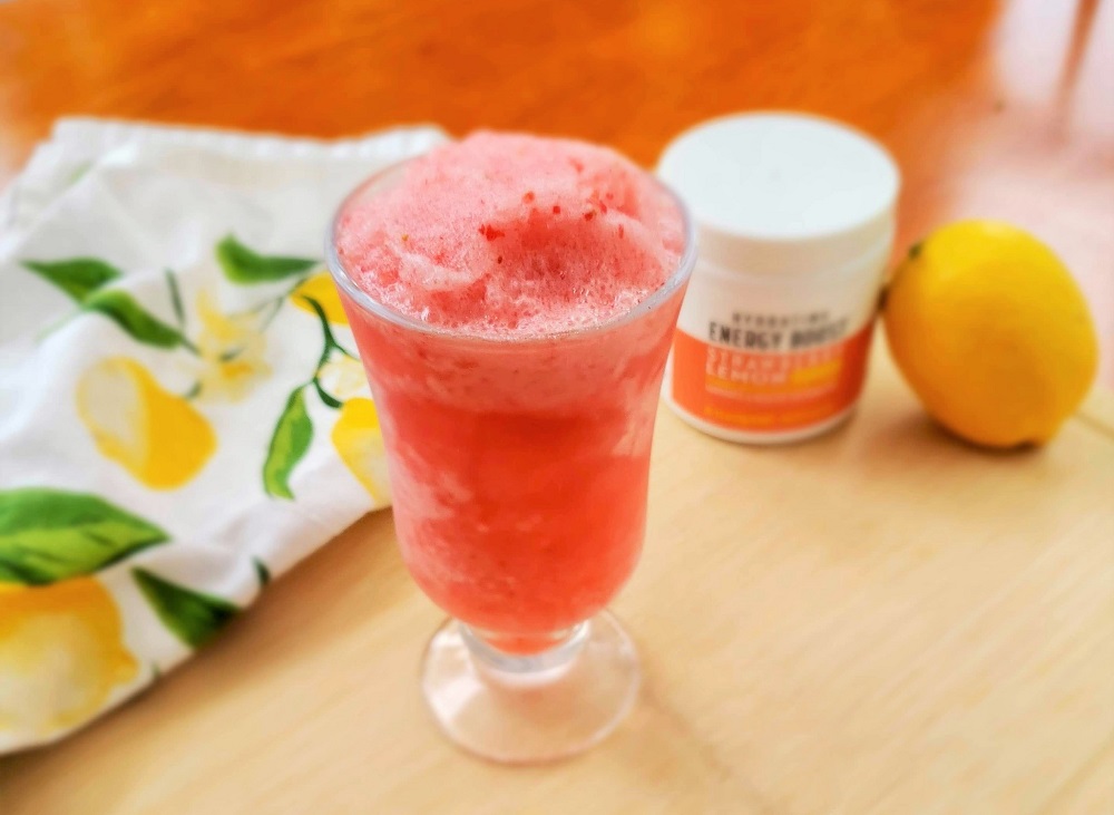 Strawberry Lemon Slushie with Nutrisystem Hydrating Energy Boost, lemon and lemon towel on cutting board
