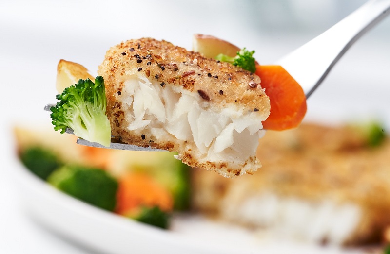 Grain Crusted Pollock with vegetables on a fork