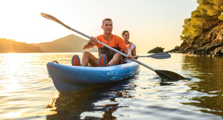 A man and woman kayaking together on a lake