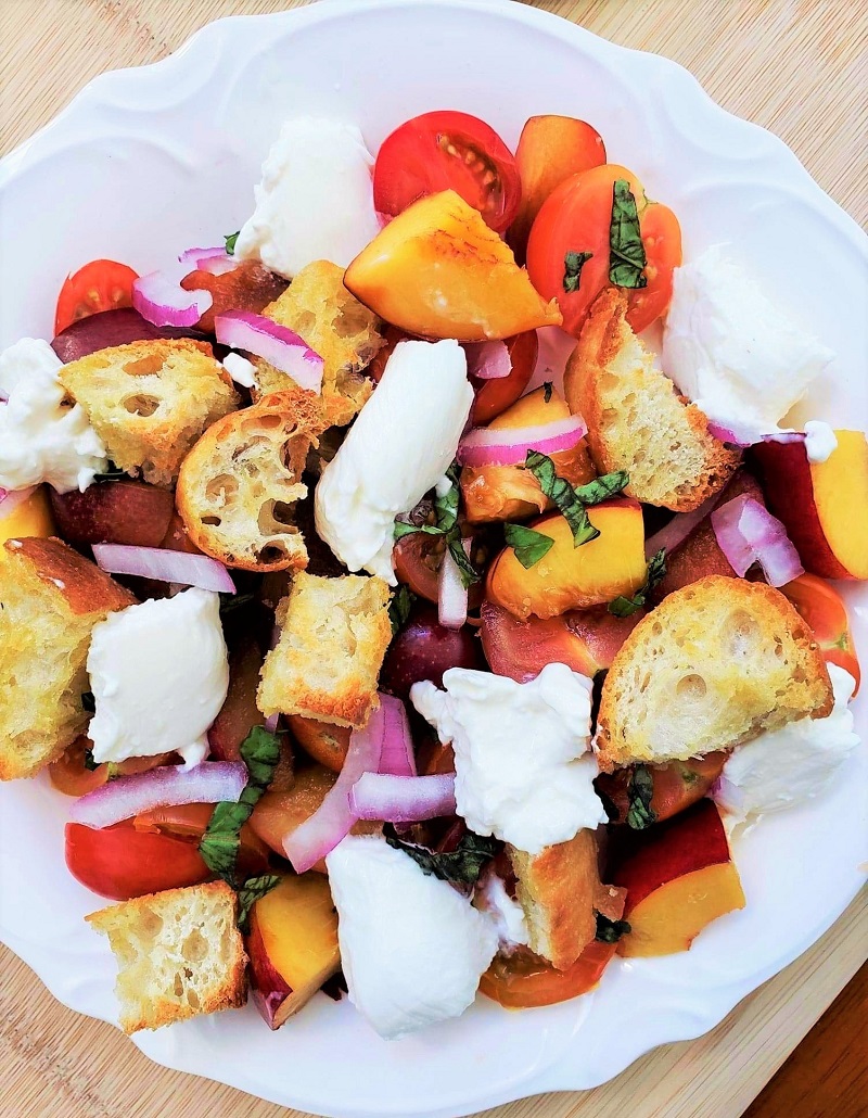 Colorful Summer Panzanella Salad on a white plate