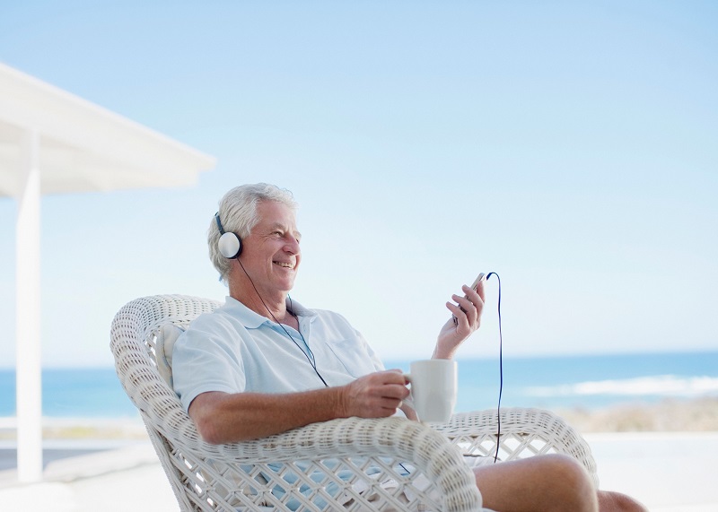 man listening to summer music playlist outside