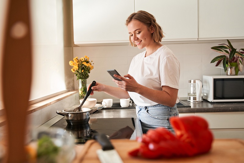 woman cooking on phone