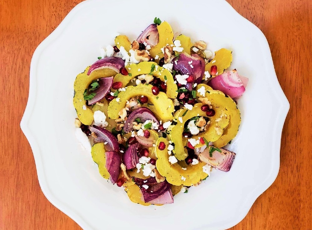 Roasted Delicata Squash Fall Salad with walnuts, pomegranate seeds, feta cheese and herbs