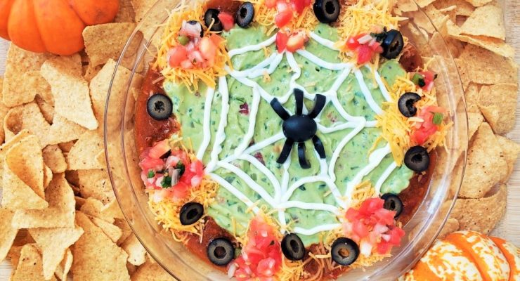 Halloween Taco Dip with a spiderweb and spider design