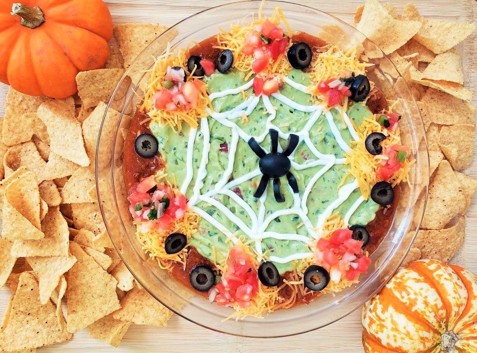 Halloween Taco Dip with a spiderweb and spider design