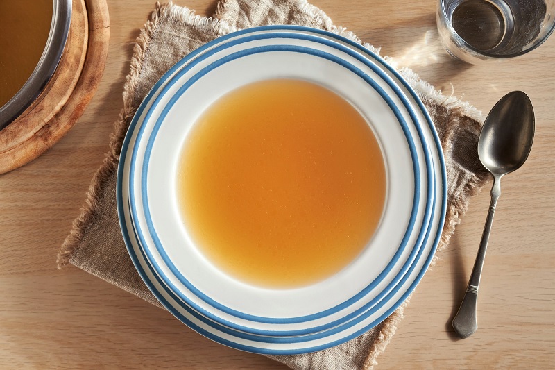 A plate of beef bone broth on a table