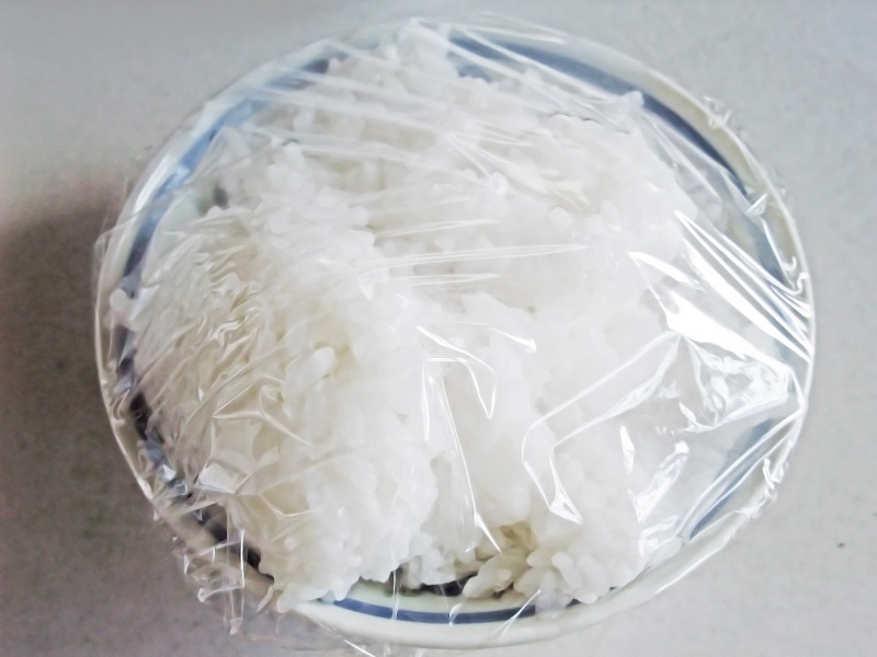 leftover rice in a bowl with plastic wrap 