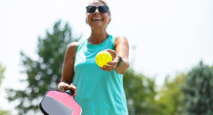 woman serving pickleball