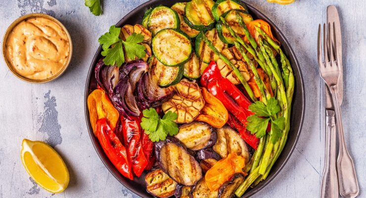 Grilled vegetables on a plate with sauce