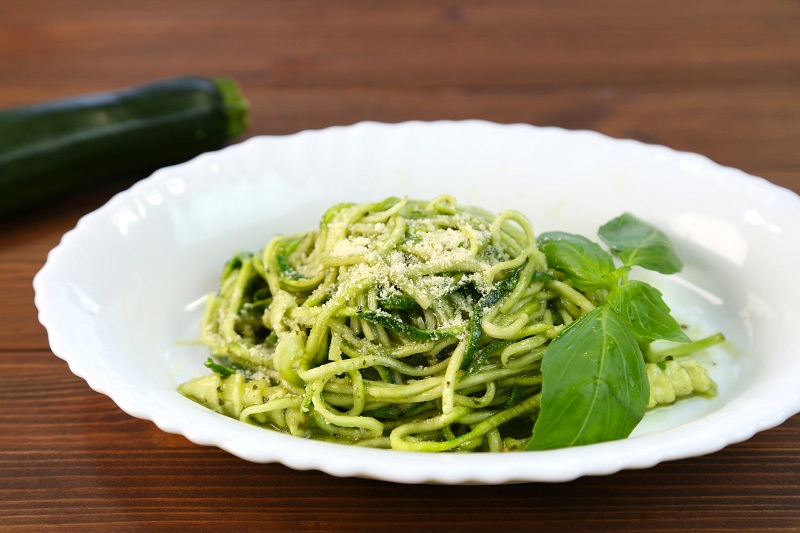 healthy veggie side dish of zucchini noodles with pesto