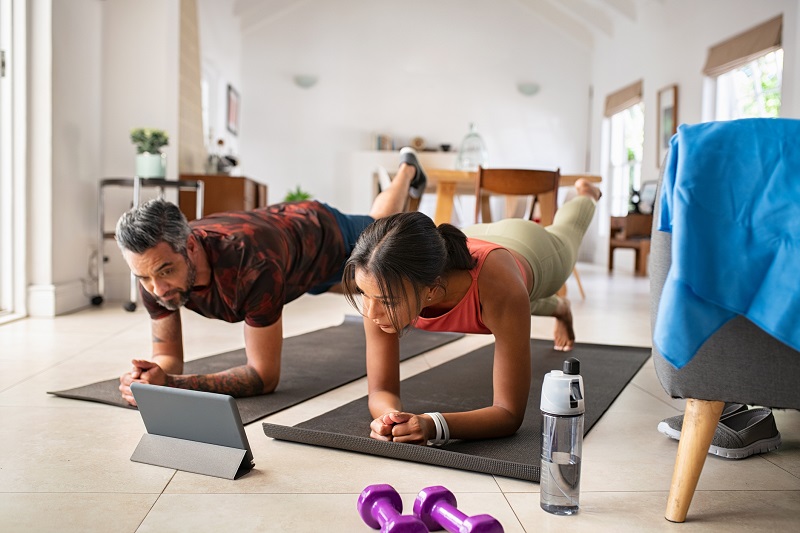 man and woman doing home workout