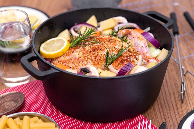 cast iron cookware pot with a chicken and veggie meal