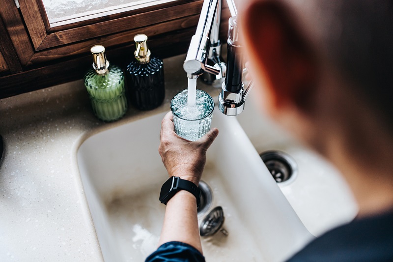 man filling up a water glass